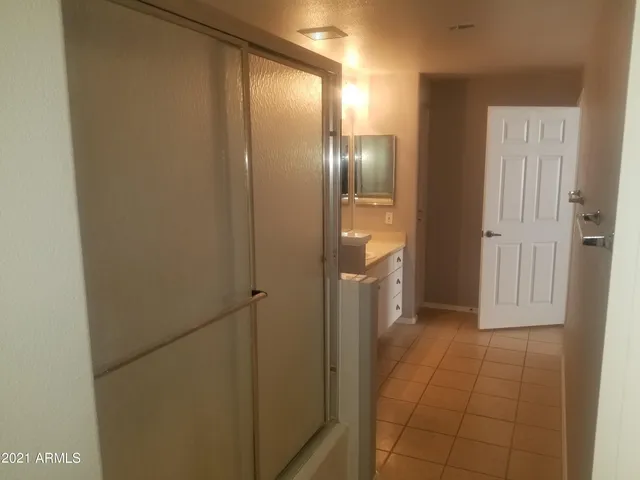 a bathroom with a shower and closet