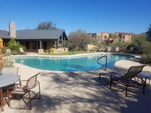 a view of a house with backyard porch and sitting area
