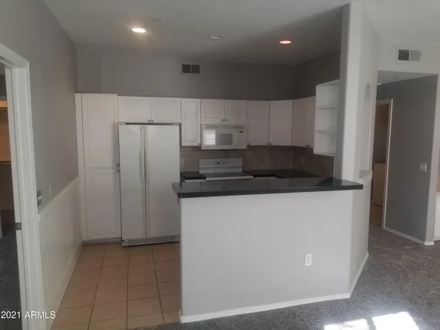 a refrigerator freezer sitting inside of a kitchen