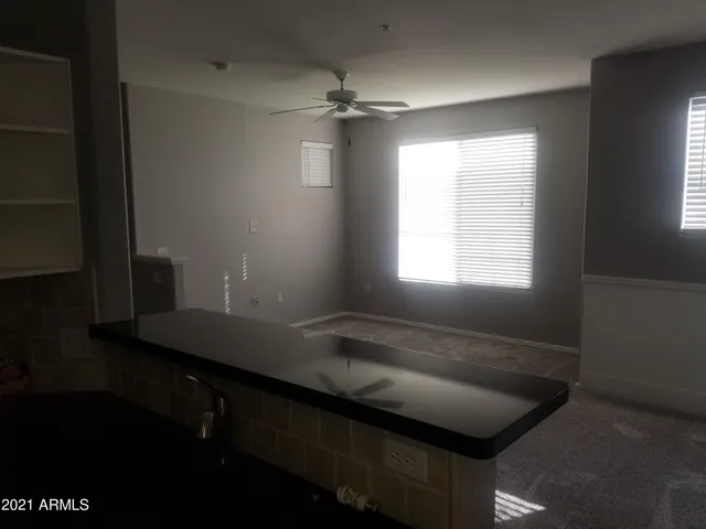 a room with a window and a chandelier