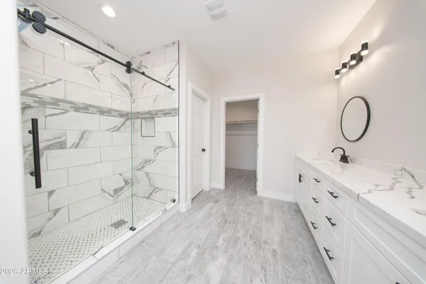 a bathroom with a double vanity sink a and a shower