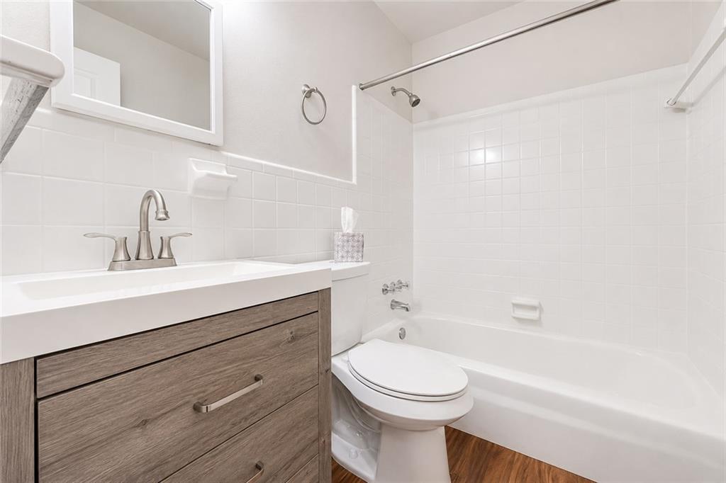 3203 East Point Street, Unit 4 Atlanta, GA 30344 - Photo 9 of 18 a bathroom with a sink a toilet and shower