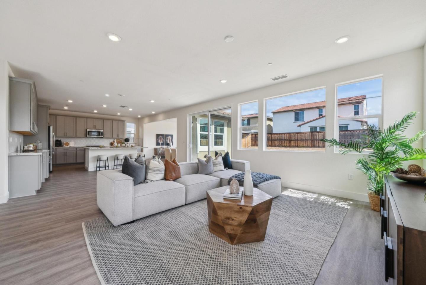 a living room with furniture and view of kitchen