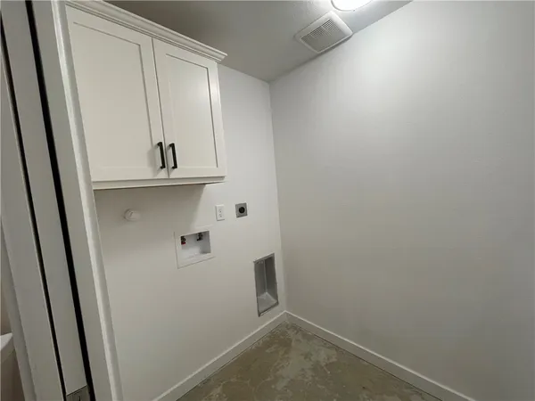 a view of storage and utility room with wooden floor