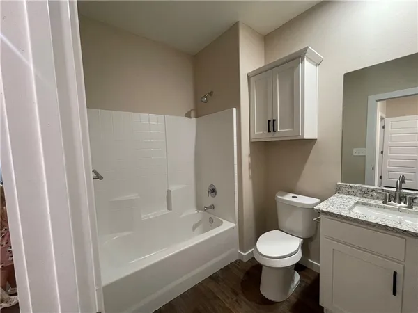 a bathroom with a toilet a sink and bathtub