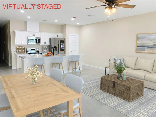 a living room with kitchen island furniture and a chandelier