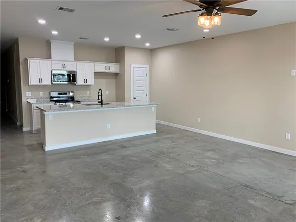 a kitchen with stainless steel appliances a refrigerator and a stove top oven