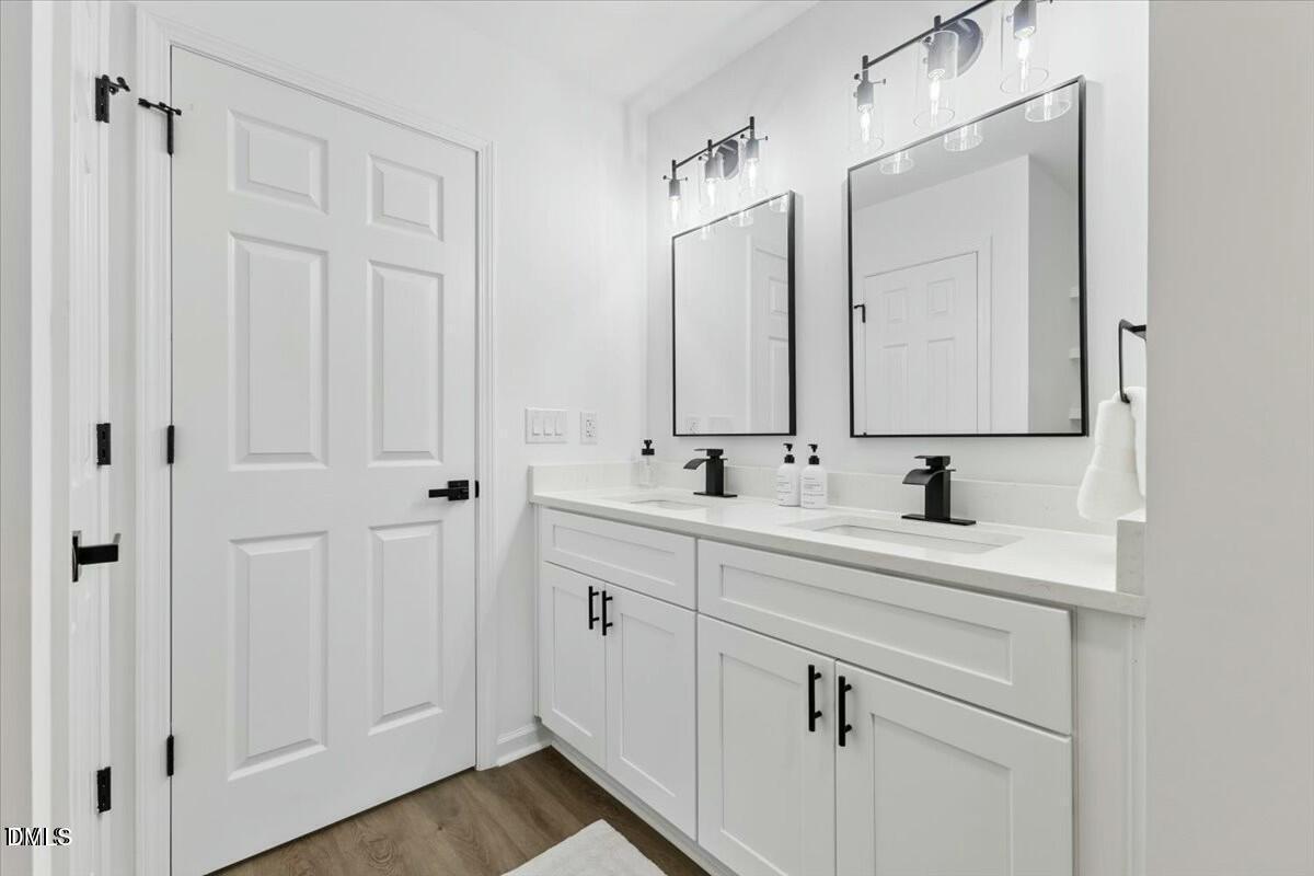 606 Cecil Street Durham, NC 27707 - Photo 14 of 25 a bathroom with a sink and a mirror