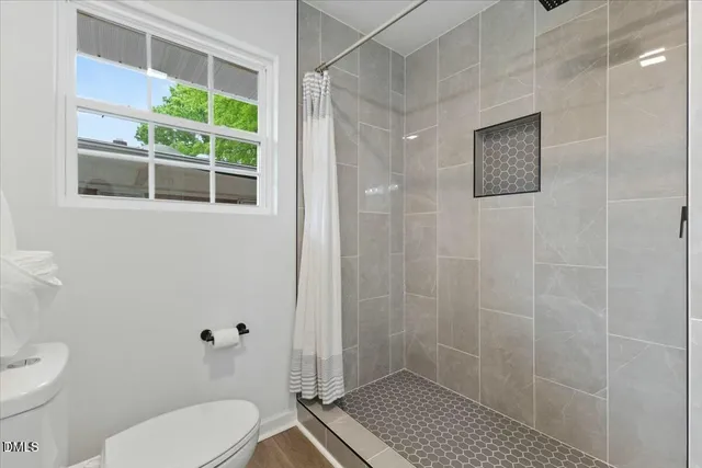 a bathroom with a toilet a sink and a shower