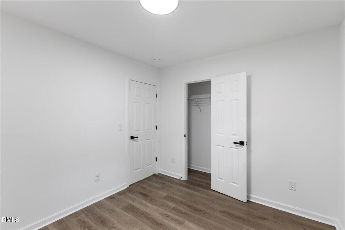 606 Cecil Street Durham, NC 27707 - Photo 17 of 25 a view of an empty room with wooden floor