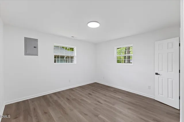 a view of a room with wooden floor and windows