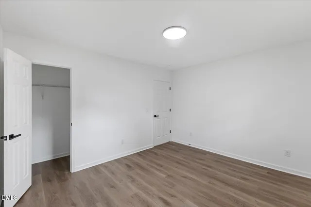 a view of a room with wooden floor