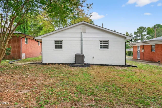 a view of a backyard with a garden and garage
