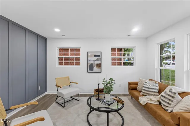 a living room with furniture potted plant and window