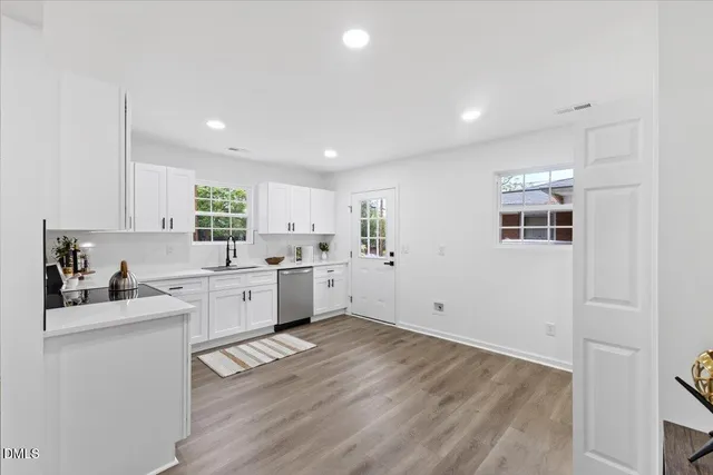 a kitchen with a sink window and cabinets