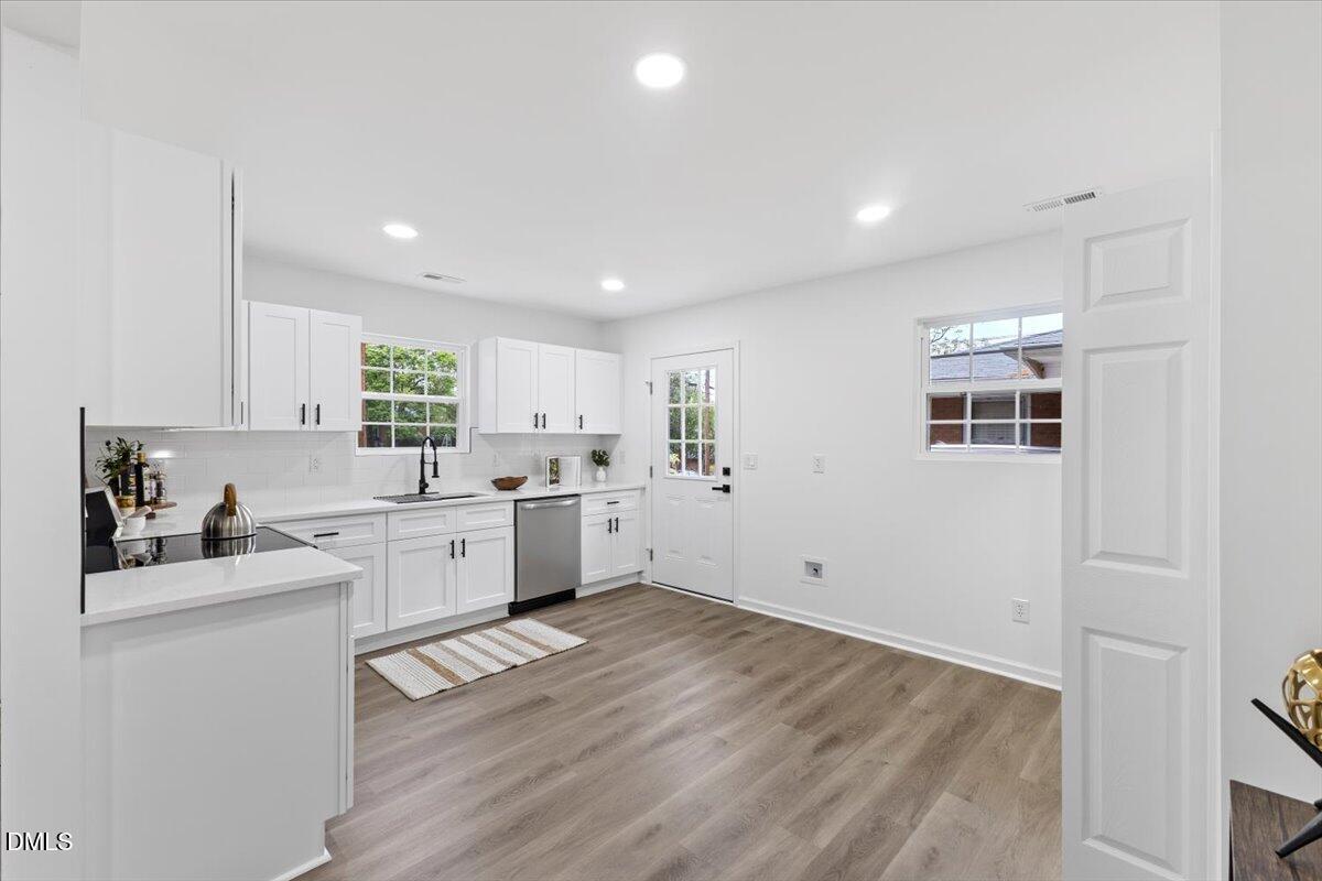606 Cecil Street Durham, NC 27707 - Photo 10 of 25 a kitchen with a sink window and cabinets