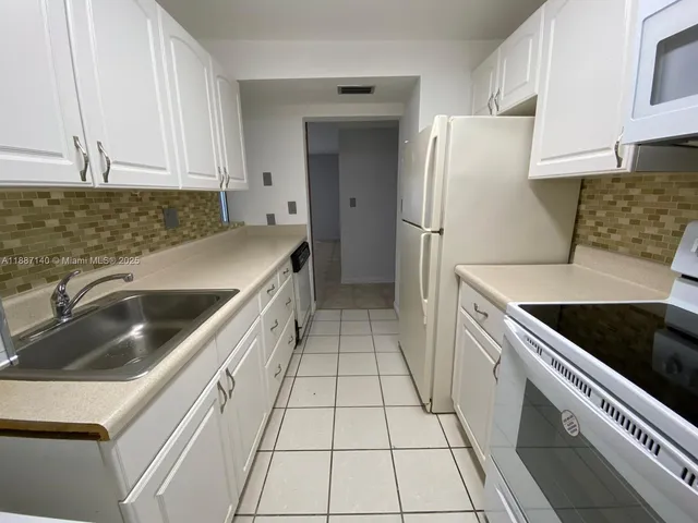 a kitchen with a sink a stove and refrigerator