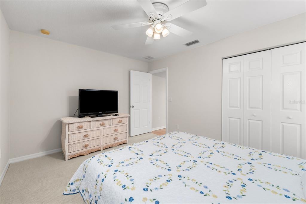 7418 White Oaks Road Alachua, FL 32615 - Photo 25 of 46 a bedroom with a bed and a flat screen tv