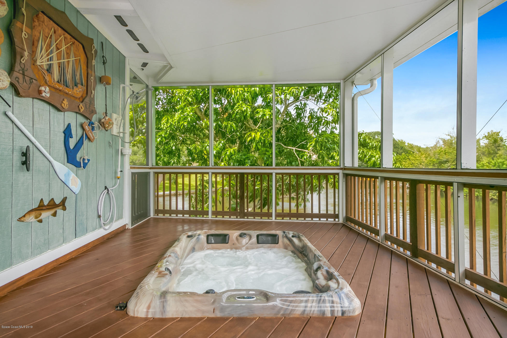 1191 Sunswept Road Northeast Palm Bay, FL 32905 - Photo 18 of 40 Screened back porch w/hot tub