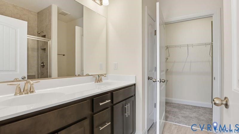 1792 Outrigger Drive Chester, VA 23836 - Photo 25 of 45 a bathroom with a sink and a mirror