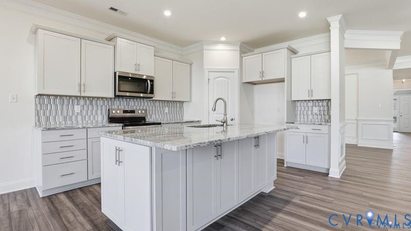 1792 Outrigger Drive Chester, VA 23836 - Photo 4 of 45 a kitchen with white cabinets and stainless steel appliances