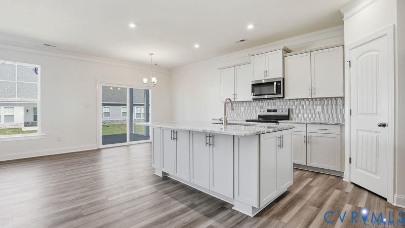 1792 Outrigger Drive Chester, VA 23836 - Photo 7 of 45 a kitchen with cabinets and wooden floor