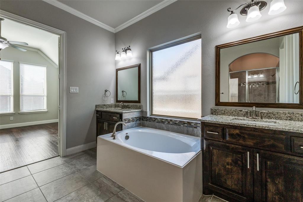 4412 Evenstar Way Plano, TX 75074 - Photo 14 of 30 a bathroom with a tub sink and mirror