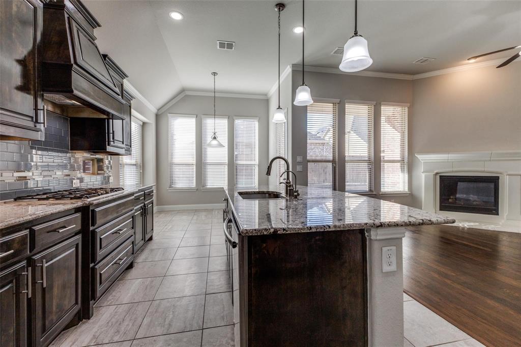 4412 Evenstar Way Plano, TX 75074 - Photo 27 of 30 a kitchen with stainless steel appliances granite countertop a sink a stove and a wooden floors
