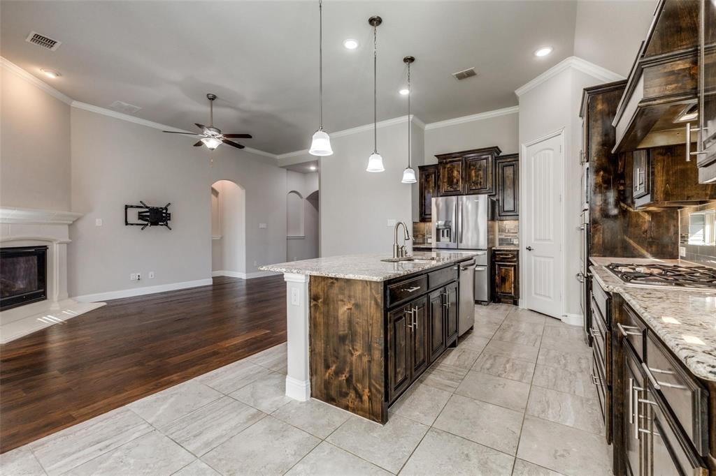 4412 Evenstar Way Plano, TX 75074 - Photo 28 of 30 a kitchen with stainless steel appliances granite countertop a stove and a sink