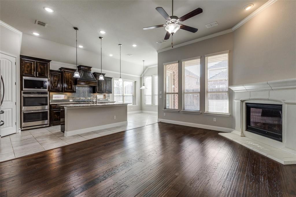 4412 Evenstar Way Plano, TX 75074 - Photo 23 of 30 a view of a kitchen with furniture and a fireplace