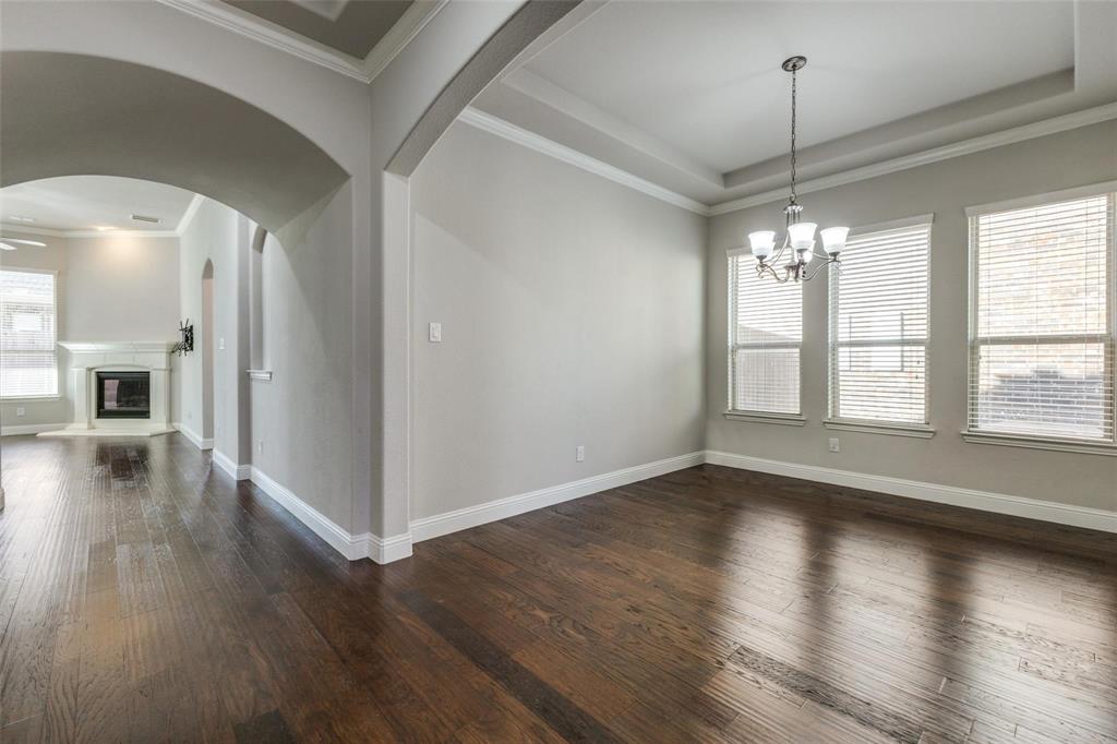 4412 Evenstar Way Plano, TX 75074 - Photo 24 of 30 a view of a livingroom with wooden floor a ceiling fan and window