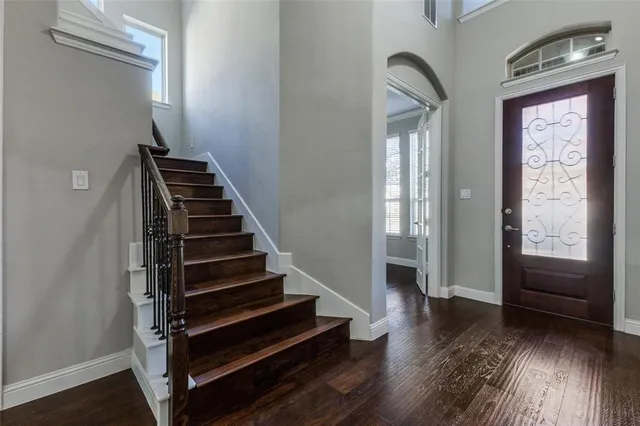 a view of entryway and hall with wooden floor