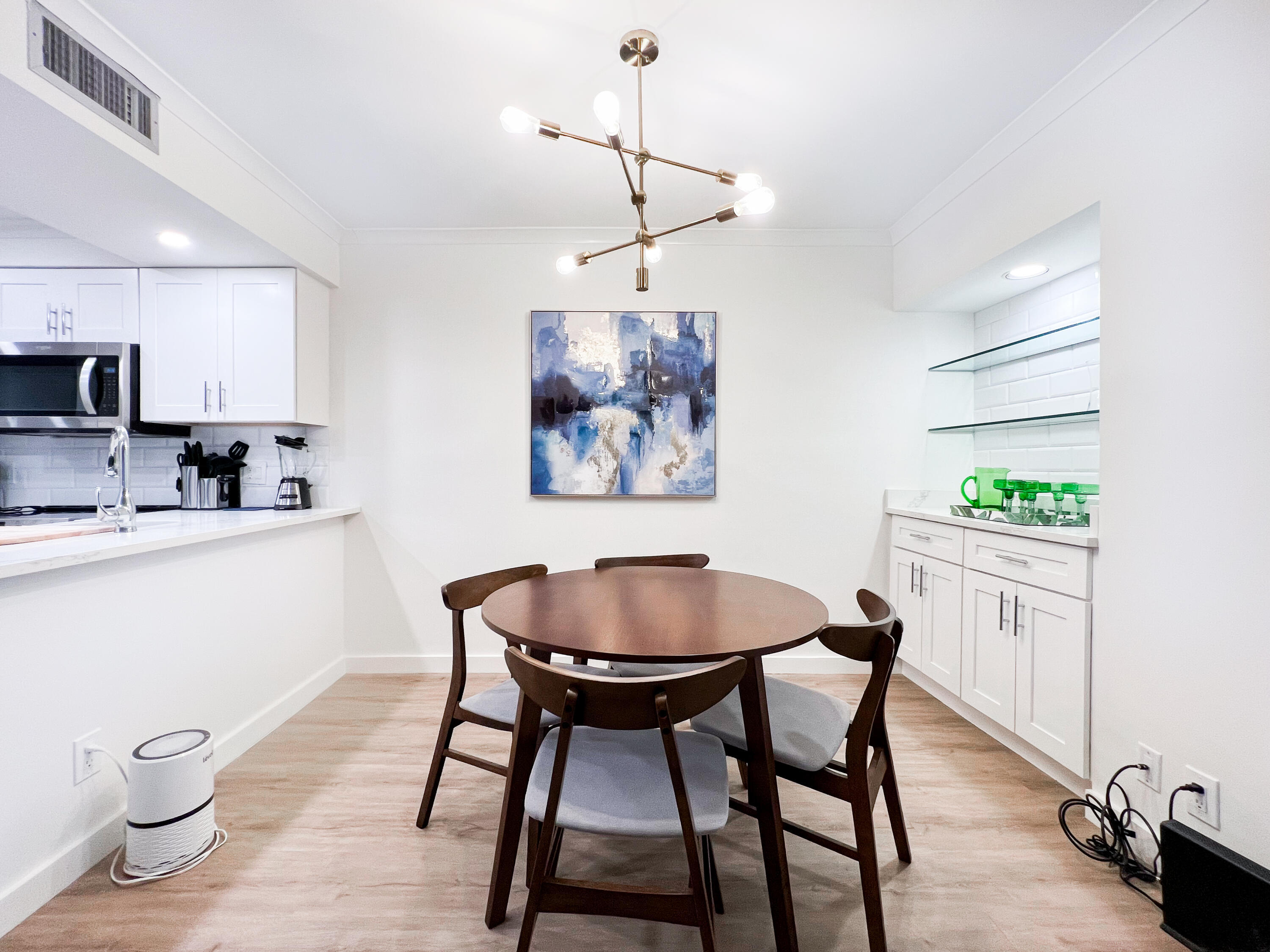 1605 Highway 1, Unit C103 Jupiter, FL 33477 - Photo 11 of 26 a view of a dining room with furniture and wooden floor