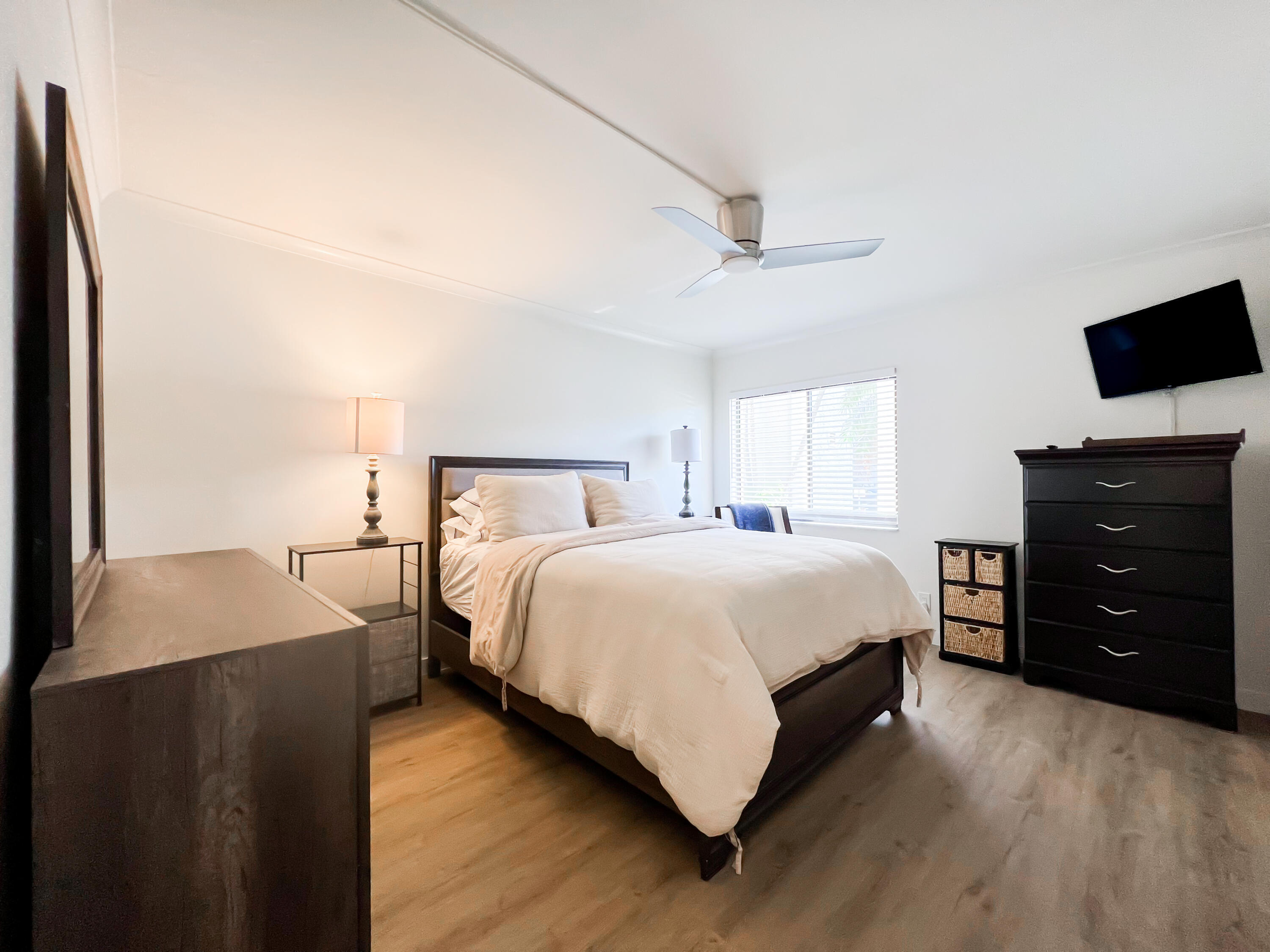 1605 Highway 1, Unit C103 Jupiter, FL 33477 - Photo 12 of 26 a bedroom with a bed and a television