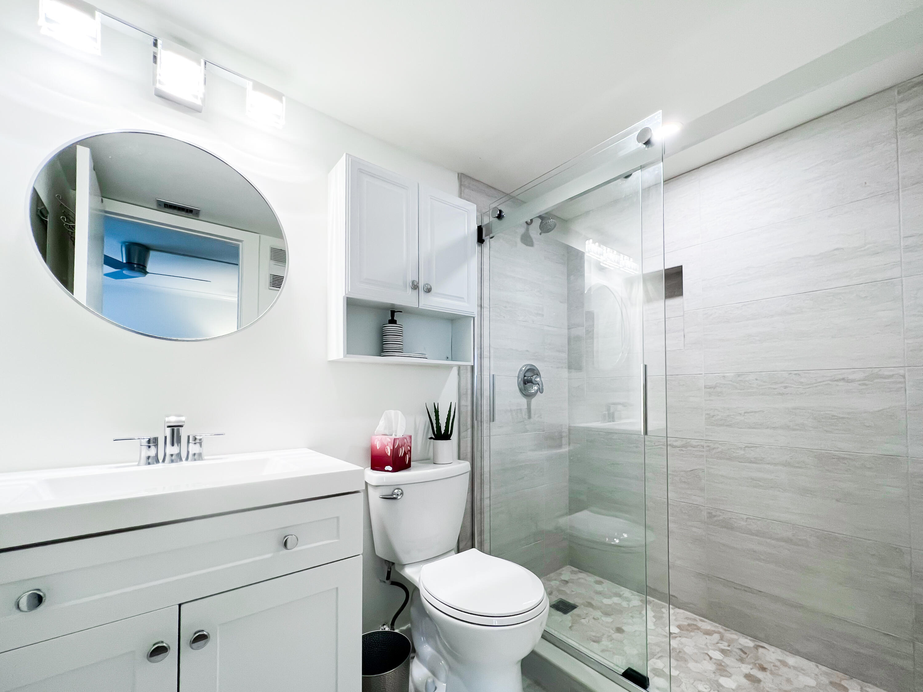 1605 Highway 1, Unit C103 Jupiter, FL 33477 - Photo 15 of 26 a bathroom with a sink toilet and shower