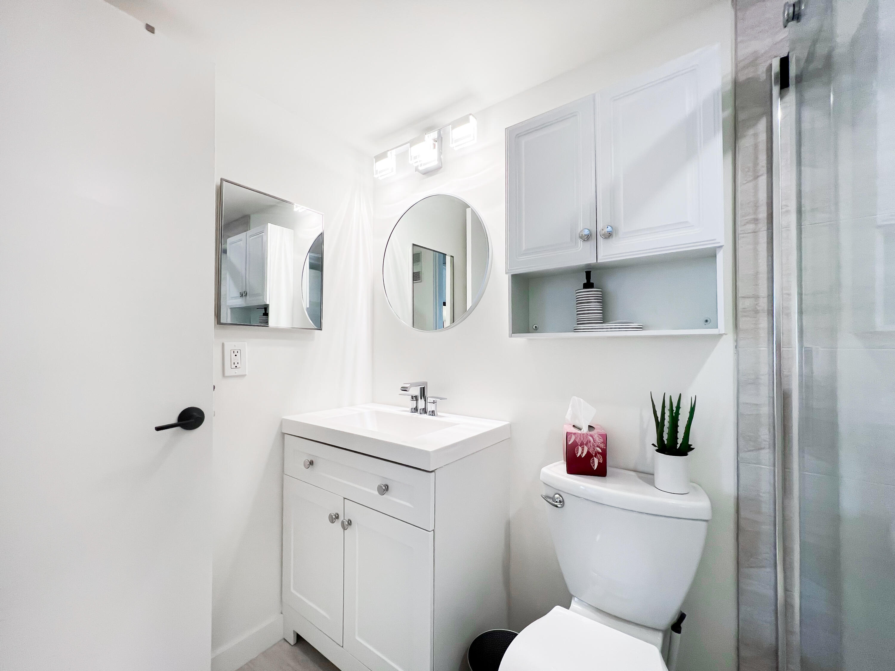 1605 Highway 1, Unit C103 Jupiter, FL 33477 - Photo 16 of 26 a bathroom with a toilet sink and mirror