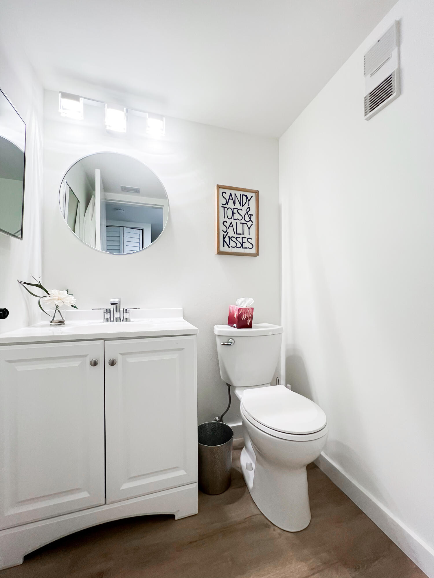 1605 Highway 1, Unit C103 Jupiter, FL 33477 - Photo 19 of 26 a bathroom with a toilet sink and mirror