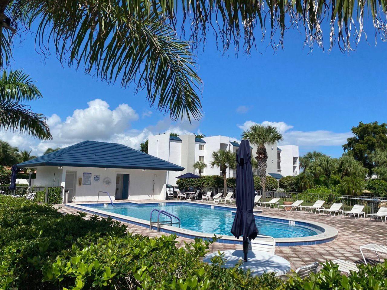 1605 Highway 1, Unit C103 Jupiter, FL 33477 - Photo 26 of 26 a front view of a house with yard and entryway