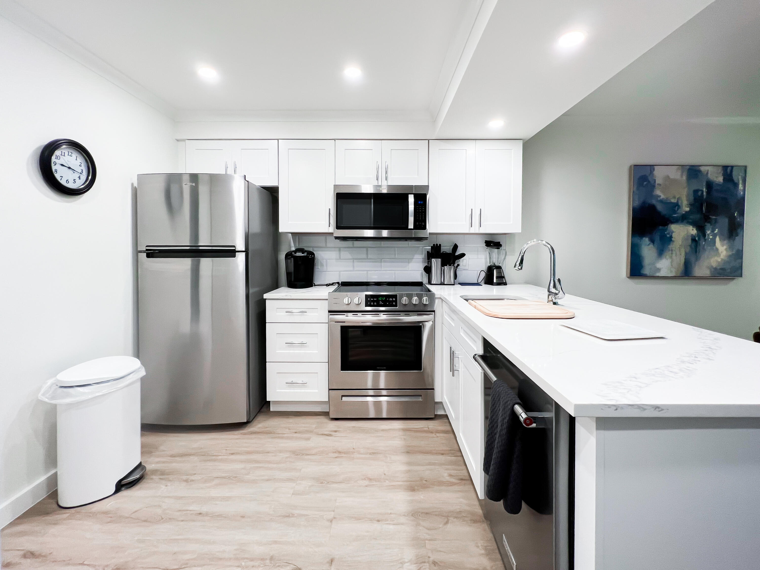 1605 Highway 1, Unit C103 Jupiter, FL 33477 - Photo 4 of 26 a kitchen with a sink a stove and a refrigerator