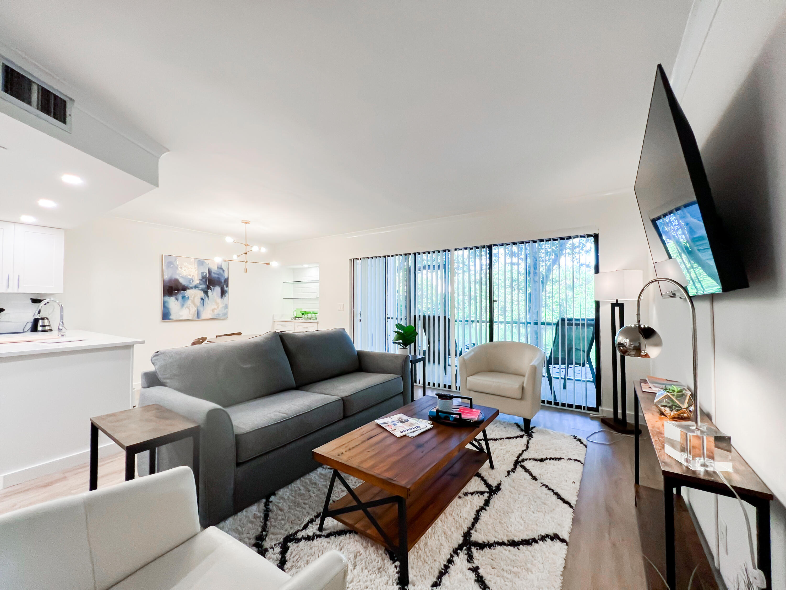 1605 Highway 1, Unit C103 Jupiter, FL 33477 - Photo 7 of 26 a living room with furniture and a flat screen tv