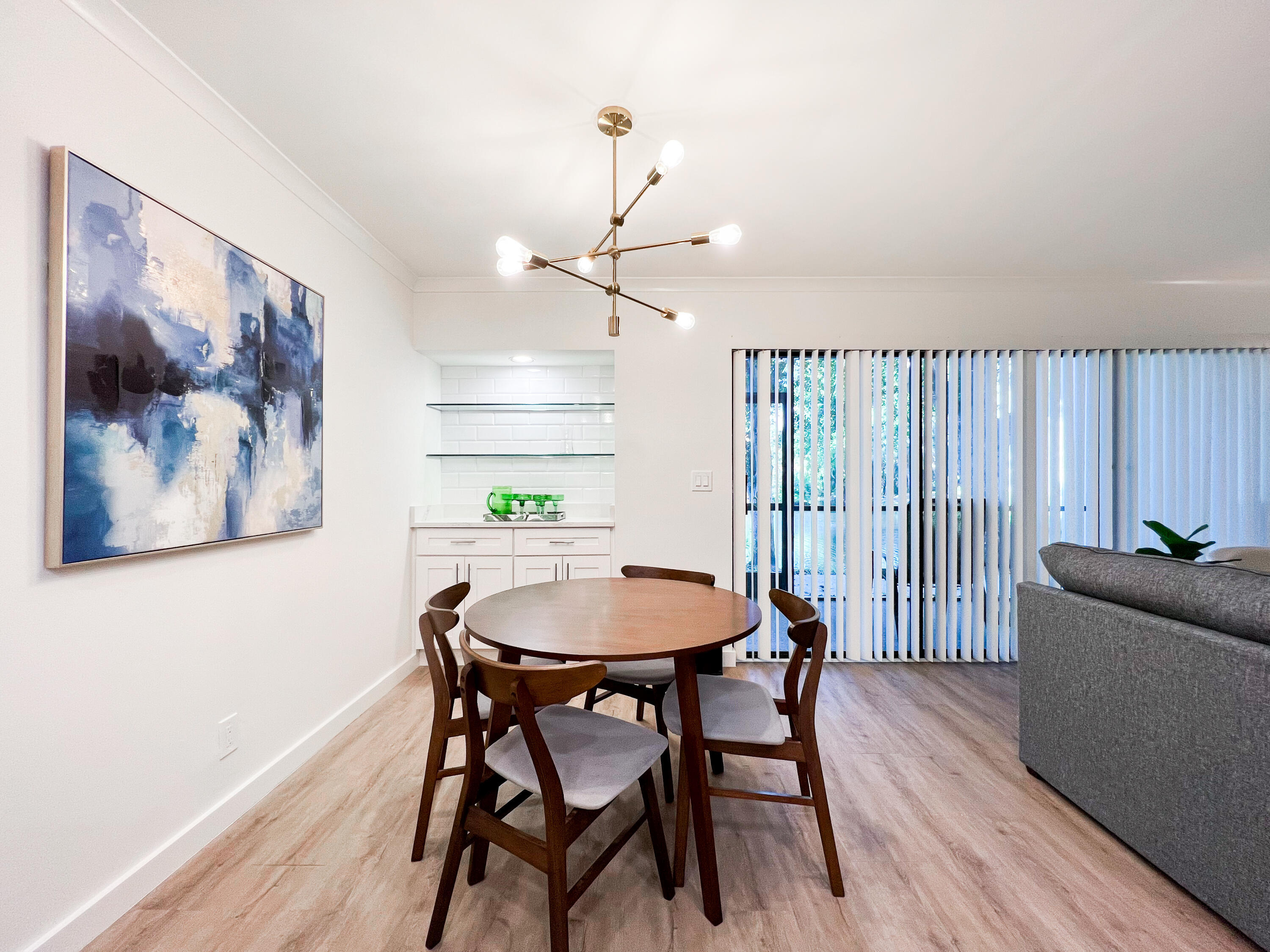 1605 Highway 1, Unit C103 Jupiter, FL 33477 - Photo 10 of 26 a view of a dining room with furniture window and wooden floor