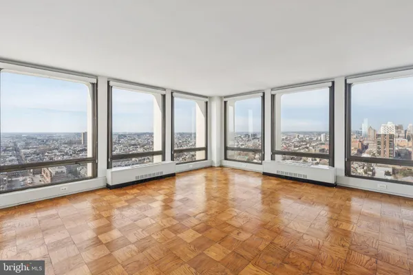 a view of an empty room with windows and city view