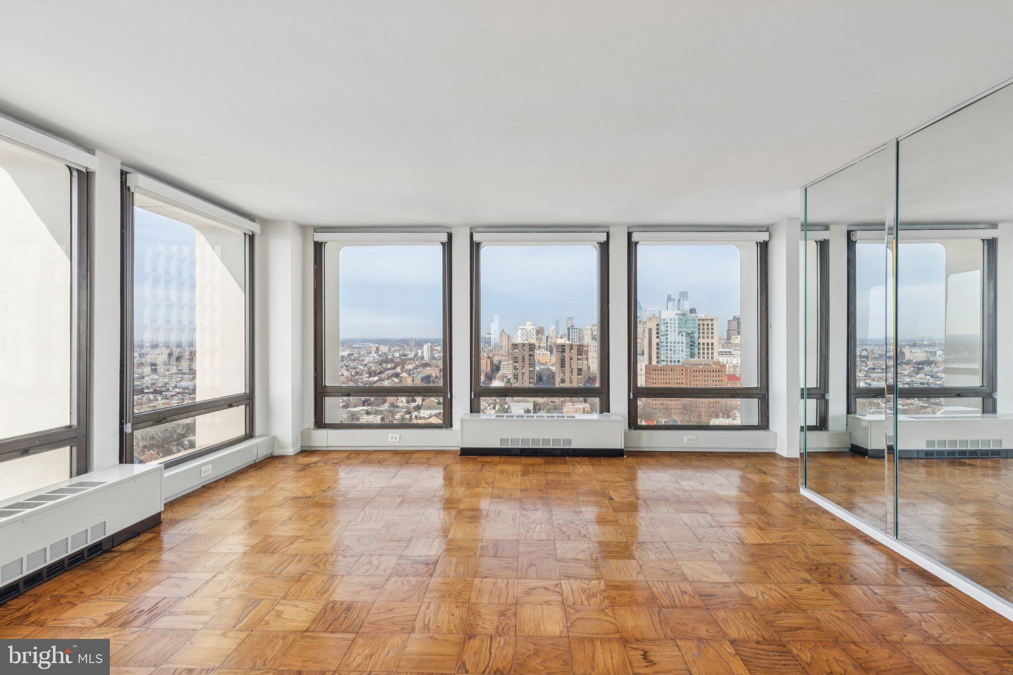 220 Locust Street, Unit 28GS Philadelphia, PA 19106 - Photo 3 of 21 a view of an empty room with large windows