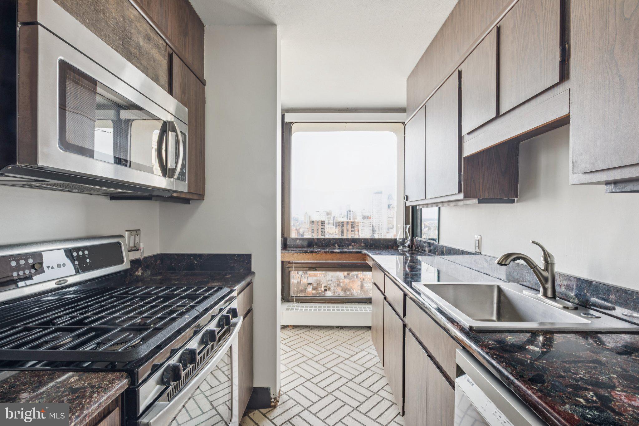 220 Locust Street, Unit 28GS Philadelphia, PA 19106 - Photo 5 of 21 a kitchen that has a sink and a stove