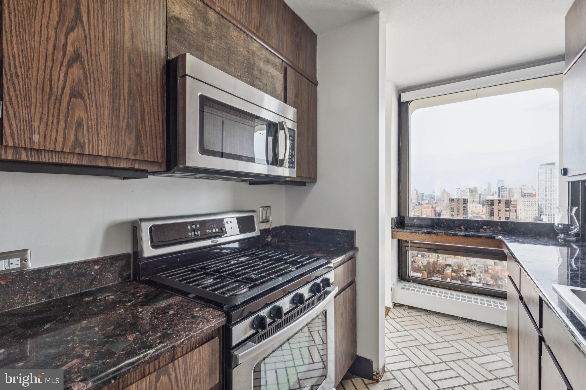 220 Locust Street, Unit 28GS Philadelphia, PA 19106 - Photo 6 of 21 a kitchen with a stove and a microwave