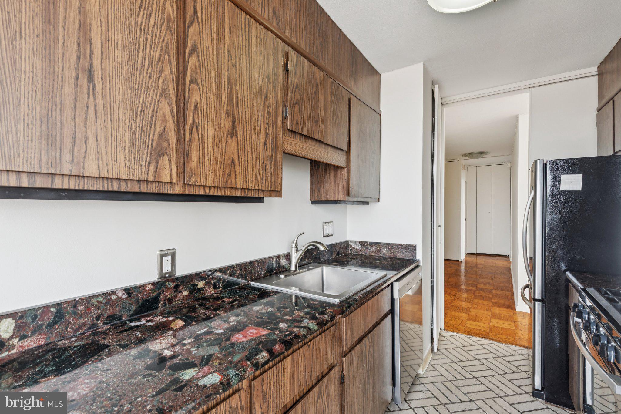 220 Locust Street, Unit 28GS Philadelphia, PA 19106 - Photo 7 of 21 a kitchen with stainless steel appliances granite countertop a sink stove and refrigerator