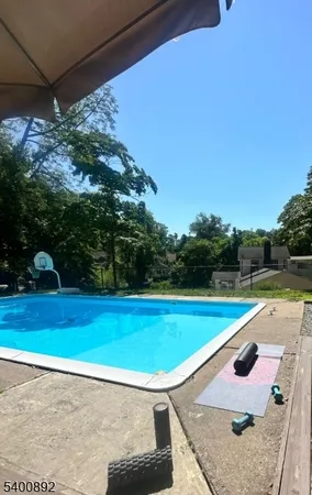 a view of a swimming pool with a yard
