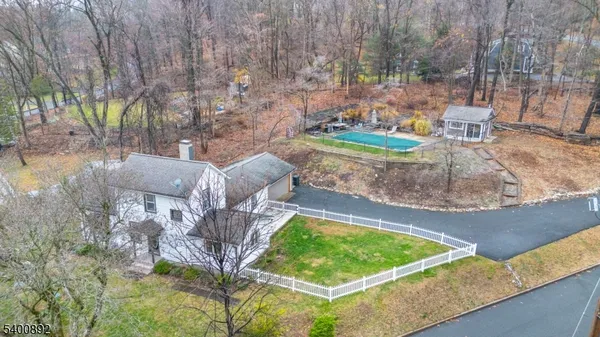a view of a backyard with wooden fence
