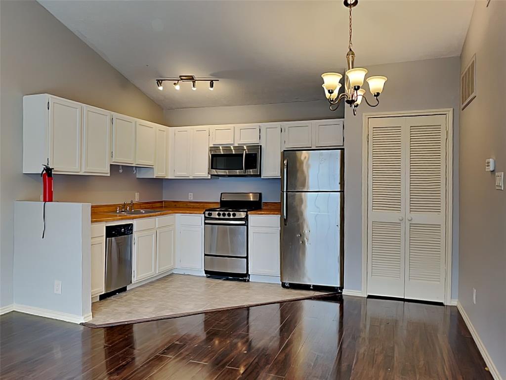 6108 Abrams Road, Unit 323 Dallas, TX 75231 - Photo 4 of 7 a kitchen with stainless steel appliances a refrigerator sink and microwave
