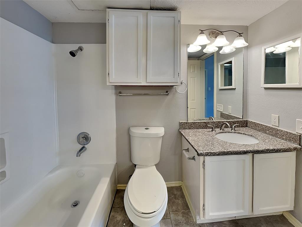 6108 Abrams Road, Unit 323 Dallas, TX 75231 - Photo 7 of 7 a bathroom with a granite countertop sink and a mirror